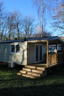 a tiny house with a porch and a deck at Oasis bora bora 4 personnes in Pamiers