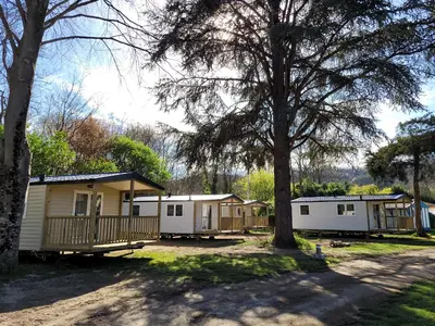 a row of mobile homes in a park at Oasis bora bora 4 personnes in Pamiers