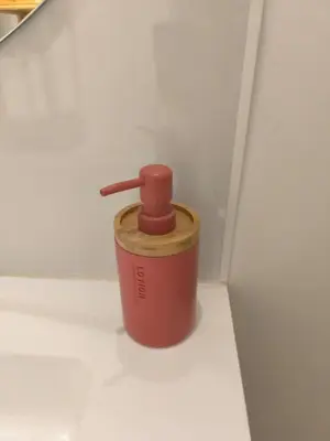 a red container with a wooden lid on a wall at Bel Appartement Terracotta au cœur de Narbonne in Narbonne