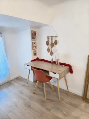 a desk with a red chair in a room at Bel Appartement Terracotta au cœur de Narbonne in Narbonne