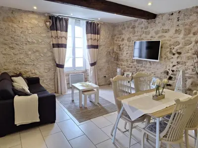 a living room with a couch and a table at La Retraite in Assignan