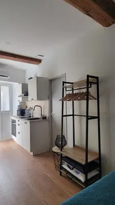 a kitchen with a bunk bed in a room at Studio au cœur de Castelnaudary in Castelnaudary