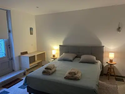 a bedroom with a bed with towels on it at La Maison de Valerie Feng Shui in La Livinière