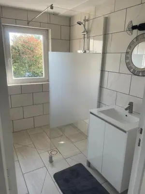 a white bathroom with a sink and a window at Havre de paix moderne aux portes du centre ville in La Celle-sous-Gouzon