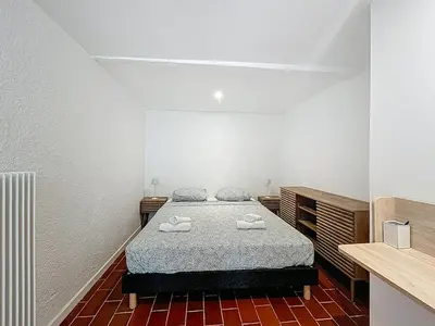 a bedroom with a bed with two towels on it at L'Oustal Maison de caractere avec Wifi et climatisation in Villedaigne
