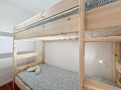a bedroom with two bunk beds in a room at L'Oustal Maison de caractere avec Wifi et climatisation in Villedaigne