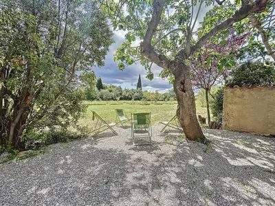a table and chairs sitting under a tree at L'Oustal Maison de caractere avec Wifi et climatisation in Villedaigne