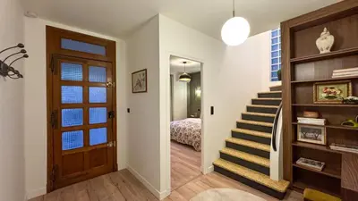 a hallway with a staircase leading to a bedroom at Maison Climatisée 5min Cité Terrasse et Parking AK in Carcassonne