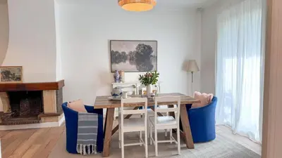 a dining room with a table and chairs and a fireplace at Maison Climatisée 5min Cité Terrasse et Parking AK in Carcassonne