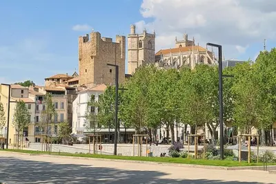 a city street with a castle in the background at Elegant 2 bedrooms flat - 8mn walk from trainstation in Narbonne
