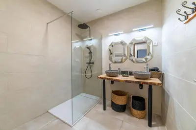 a bathroom with two sinks and a shower at Elegant 2 bedrooms flat - 8mn walk from trainstation in Narbonne