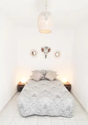 a white bedroom with a bed and two tables at Elegant 2 bedrooms flat - 8mn walk from trainstation in Narbonne