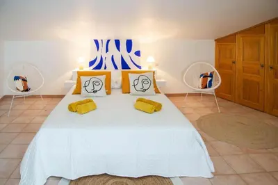 a living room with a table and a stool at Panorama by maison bacou in Carcassonne