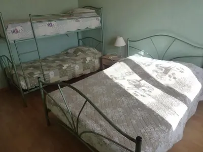 a bedroom with two bunk beds and a lamp at Jolie maison avec piscine in Sigean