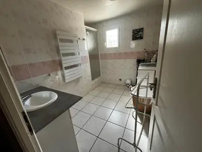 a small bathroom with a sink and a counter at Jolie maison avec piscine in Sigean