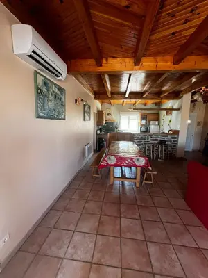 a dining room with a table in a room at Jolie maison avec piscine in Sigean