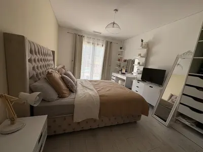 a bedroom with a bed and a flat screen tv at La Villa Solena in Ferrals-lès-Corbières
