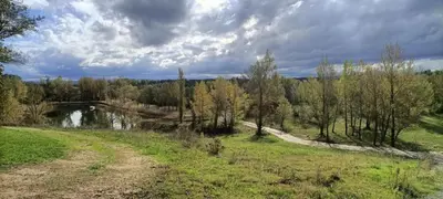 a dirt road next to a river with a bridge at Mobil home dans camping 3 étoiles in Saint-Papoul