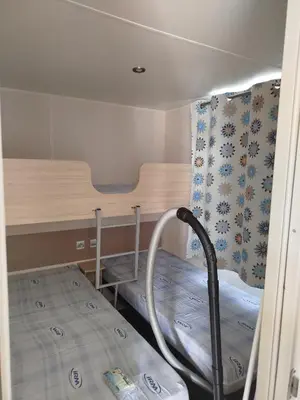 a small room with a bunk bed and a table at Mobil home dans camping 3 étoiles in Saint-Papoul