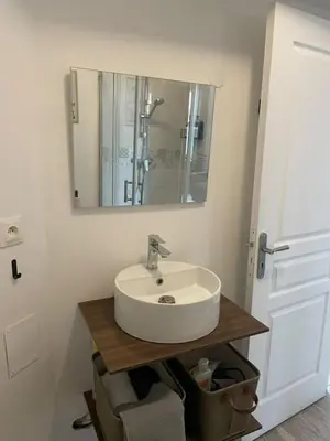 a bathroom with a sink and a mirror at Les Halles d'Isa et Thomas in Narbonne