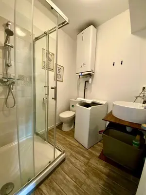 a bathroom with a shower and a toilet and a sink at Les Halles d'Isa et Thomas in Narbonne