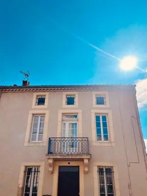 a building with a balcony on top of it at Maison de maître avec piscine et vue in Villardonnel