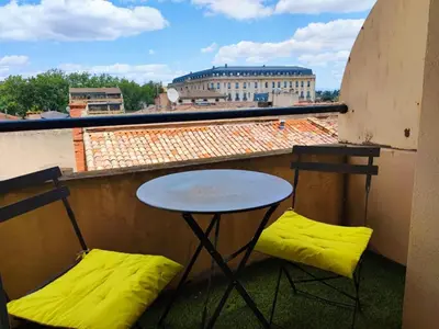 a small table and two chairs on a balcony at Casa Mistral in Carcassonne