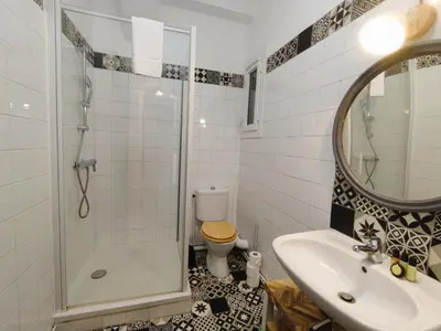 a bathroom with a shower and a sink and a toilet at Casa Mistral in Carcassonne