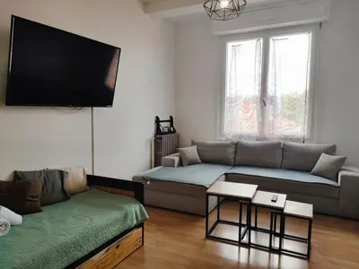 a living room with a couch and a flat screen tv at Casa Mistral in Carcassonne