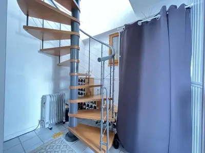 a spiral staircase in a room with a stair case at Très joli chalet privatif à Gruissan - Plage à 50 m - GN600-280 in Gruissan