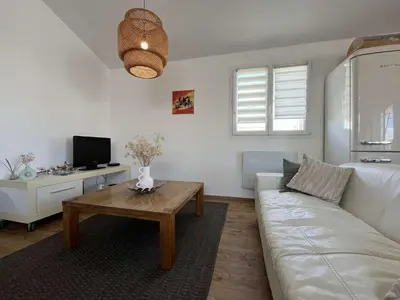 a living room with a white couch and a coffee table at Très joli chalet privatif à Gruissan - Plage à 50 m - GN600-280 in Gruissan