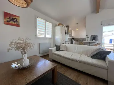 a living room with a white couch and a table at Très joli chalet privatif à Gruissan - Plage à 50 m - GN600-280 in Gruissan
