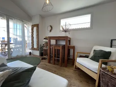 a living room with a couch and a table at Très joli chalet privatif à Gruissan - Plage à 50 m - GN600-280 in Gruissan