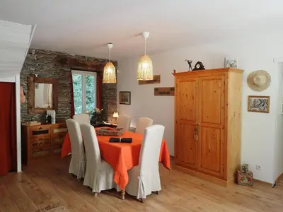 a dining room with a table and chairs at Cottage by River with Spa near Carcassonne in Caudebronde