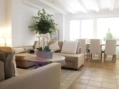 a living room with a couch and a table and chairs at Maison Bacou cité 1 in Carcassonne