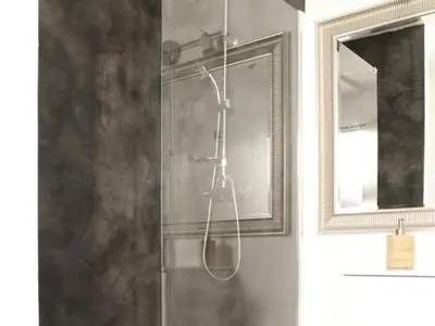 a shower in a bathroom with a glass door at Maison Bacou cité 1 in Carcassonne