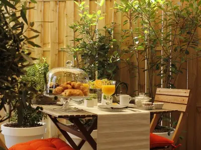 a table with a plate of bread and orange juice at Maison Bacou cité 1 in Carcassonne