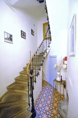 a staircase in a house with a tile floor at Carcassonne Town House, Rue Barbès in Carcassonne