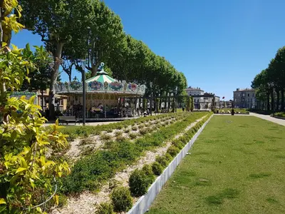 a row of trees in a park with a carousel at Carcassonne Town House, Rue Barbès in Carcassonne