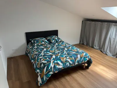 a bedroom with a bed with a colorful comforter at Apparently cozy - wifi - Netflix - air-conditioned in Labastide-dʼAnjou