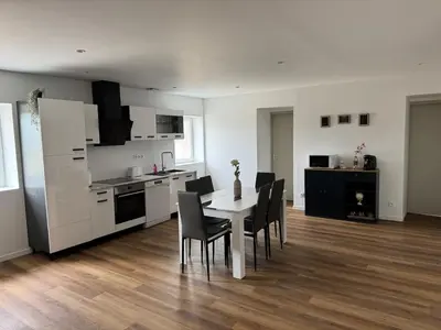 a kitchen and dining room with a table and chairs at Apparently cozy - wifi - Netflix - air-conditioned in Labastide-dʼAnjou