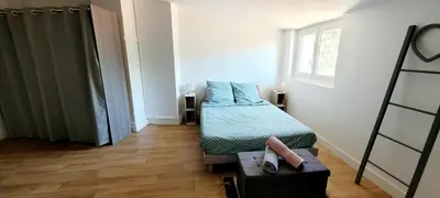 a small bedroom with a bed and a window at Logement spacieux in Carcassonne