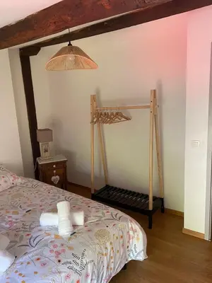 a bedroom with a bed with a wooden frame at Maison entre champs et clochers in Massaguel