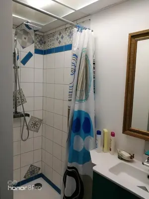 a bathroom with a shower curtain and a sink at la cassignolette in Castelnaudary