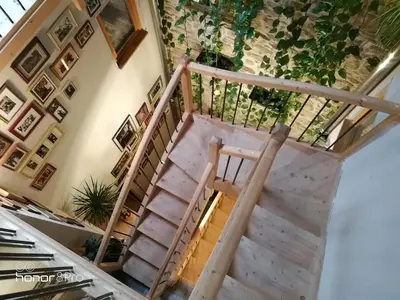 a wooden staircase in a house with a ceiling at la cassignolette in Castelnaudary