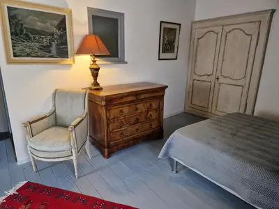 a bedroom with a desk and a chair and a lamp at Le Vieux Fusil in La Celle-sous-Gouzon