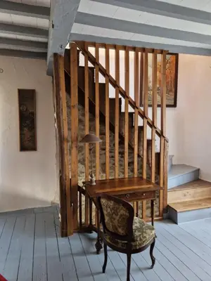 a wooden staircase with a desk and a chair at Le Vieux Fusil in La Celle-sous-Gouzon