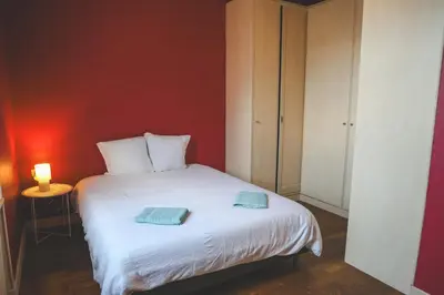 a bedroom with a white bed with two towels on it at Le Nid Urbain, terrasse, garage et confort in Carcassonne