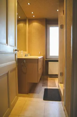 a bathroom with a tub and a sink and a window at Le Nid Urbain, terrasse, garage et confort in Carcassonne