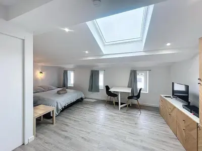 a bedroom with a bed and a desk and a window at La Suite Lauragaise - Studio climatisé in Villefranche-de-Lauragais